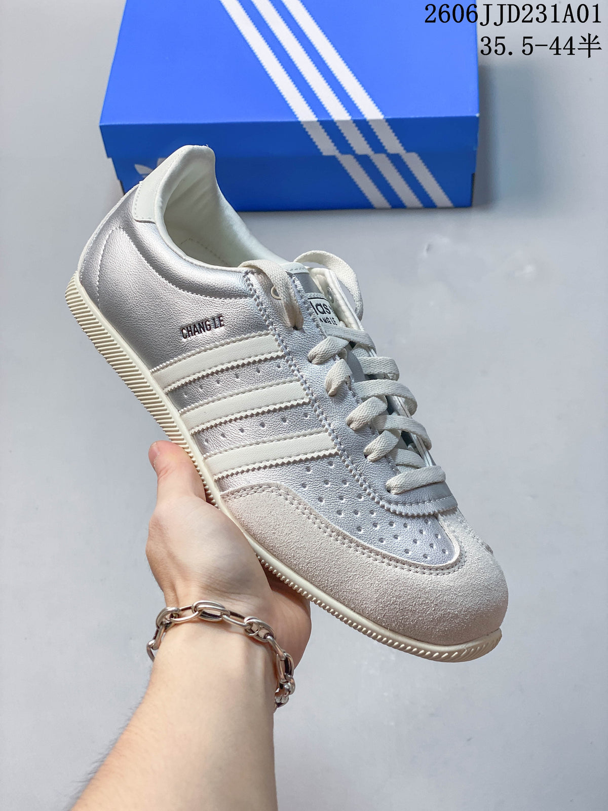 Silver Adidas Changle low-top sneaker with perforated panels and three side stripes.