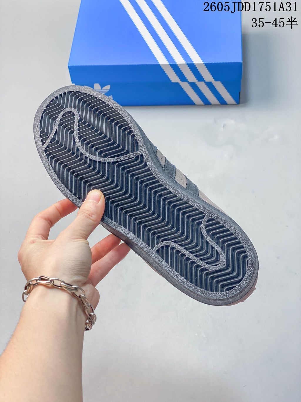 Underside of the sneaker showing the patterned dark outsole