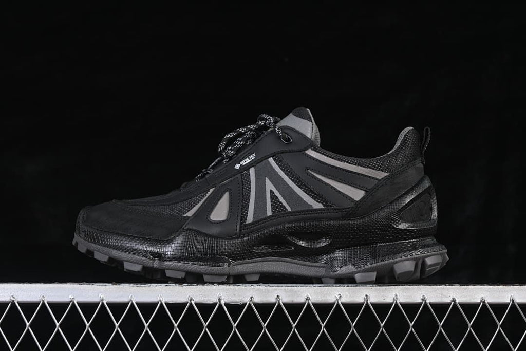 Side view of black and grey ECCO BIOM C trail-style sneaker