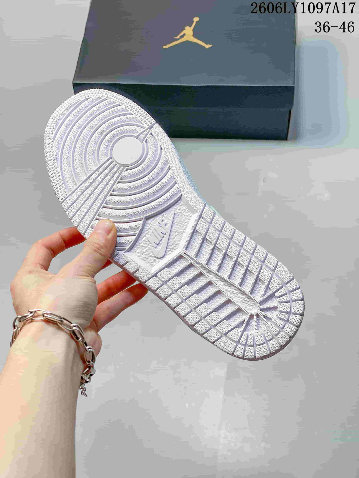 Underside of a white sneaker showing its patterned outsole