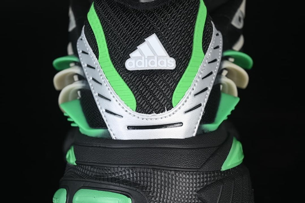 Rear close-up showing green accents, a light-colored heel panel and adidas branding