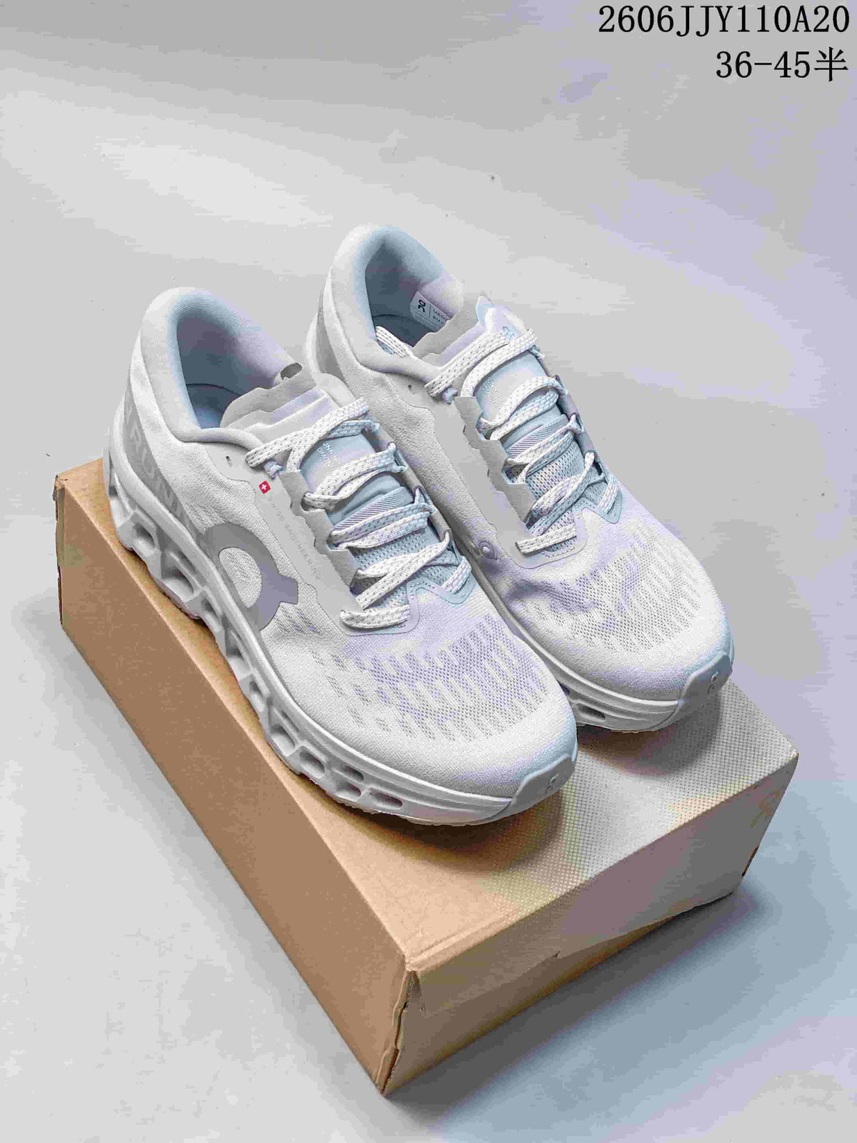 Pair of white and light gray On Cloudmonster 3 shoes on a cardboard box; image states sizes 36–45.5.