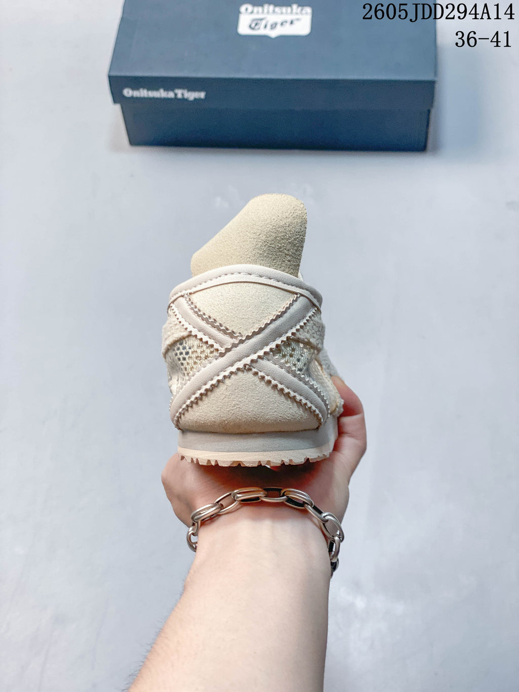 Rear view of a cream low-top sneaker showing the heel construction