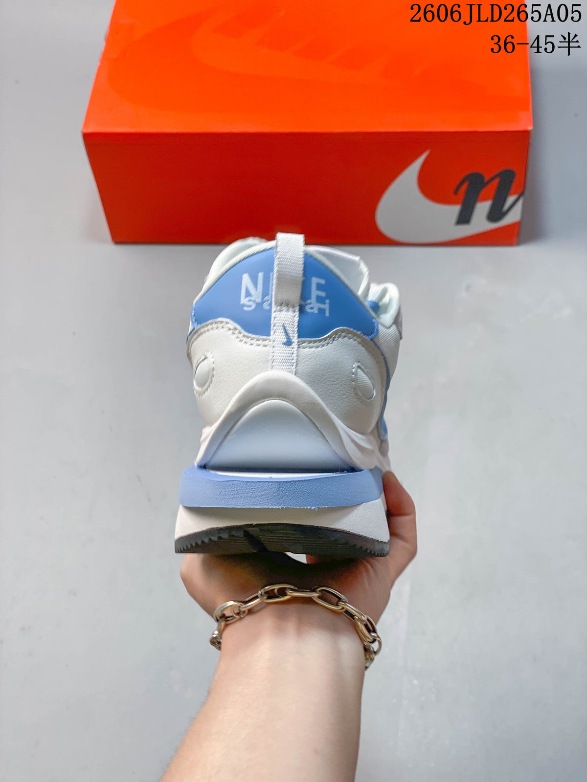 Rear view of the Nike Sacai LDWaffle sneaker with a blue heel accent