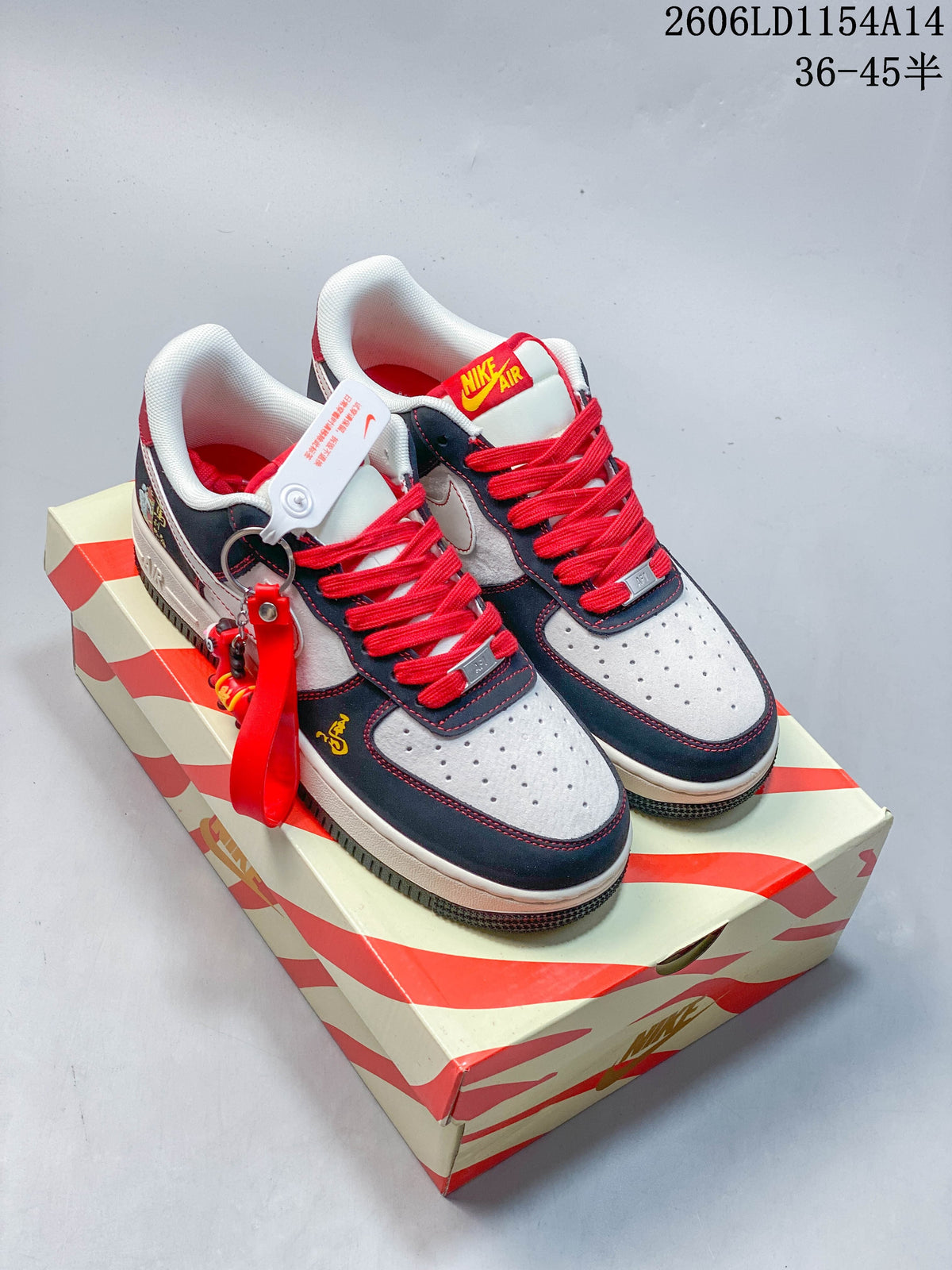 Pair of navy, white and red low-top sneakers on a patterned box