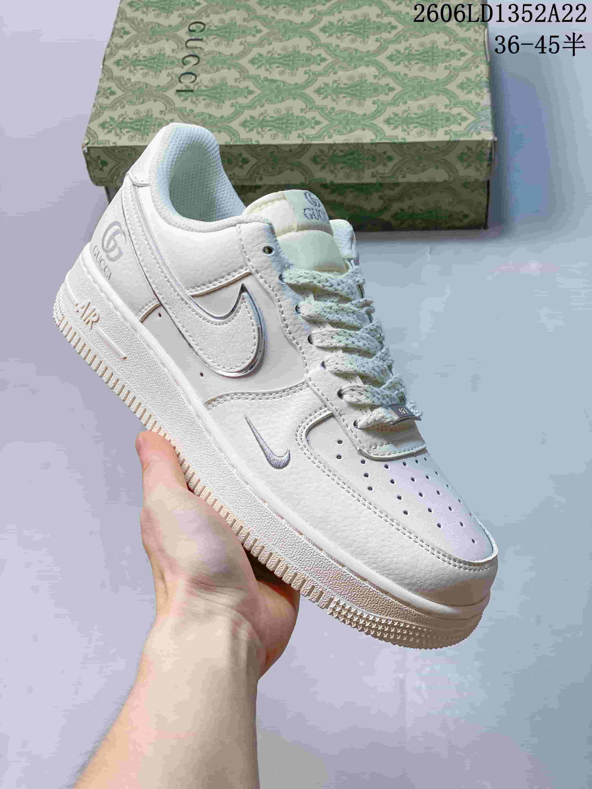 Angled close-up of the white sneaker showing side Swoosh, heel branding and lace-up design.