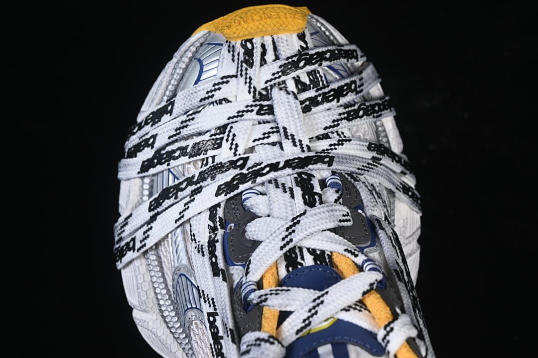 Top view of overlapping white laces with black branding
