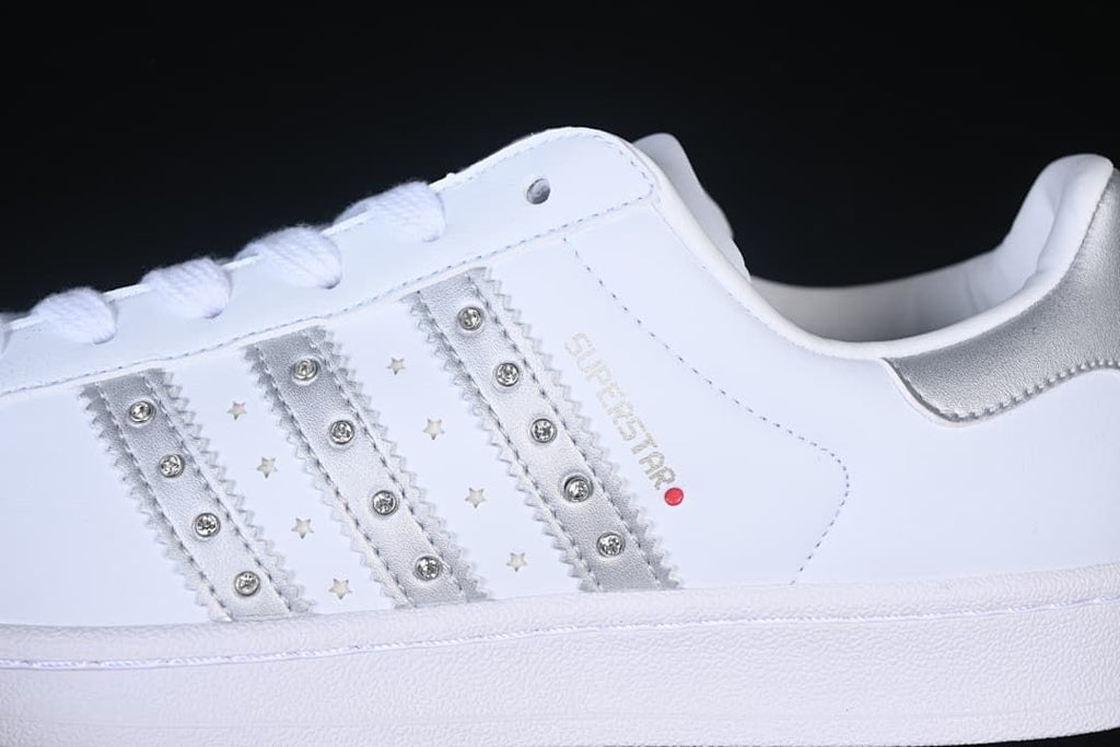 Close-up of silver side stripes with stud and star details