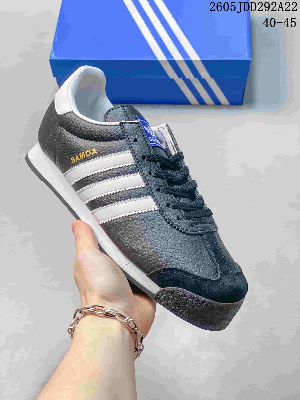 Dark gray Adidas Samoa low-top sneaker with pale stripes