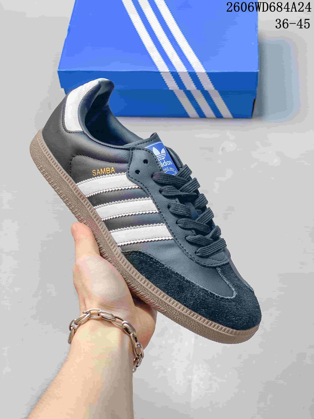 Charcoal and white low-top sneaker with dark laces and gum-style sole.