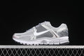 Side view of a silver and grey Nike Zoom Vomero 5 SP sneaker