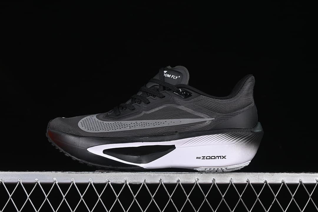 Side view of black and gray Nike Zoom Fly 6 running shoe with a white midsole