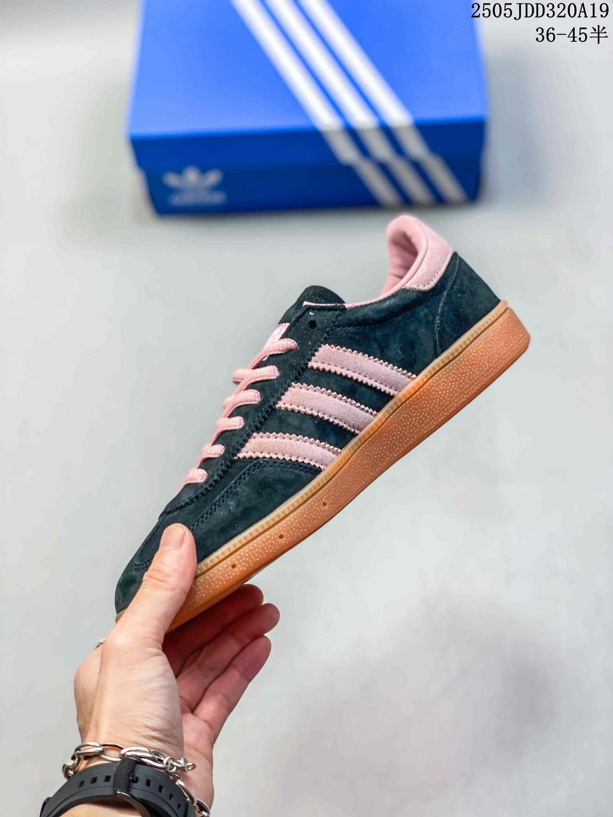 Side view showing pink stripes, dark upper and gum-colored sole
