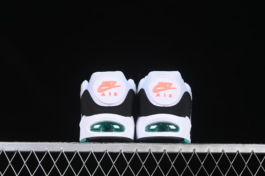 Rear view of both sneakers showing coral heel emblems and teal-tinted air units.