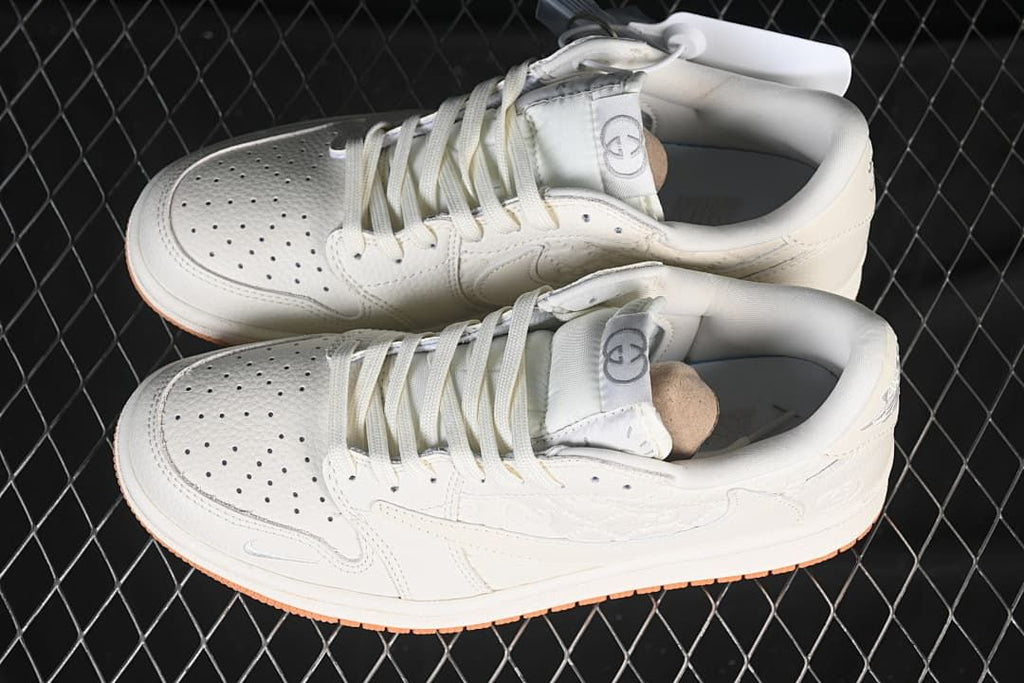 Overhead view of a pair of off-white low-top sneakers with perforated toes and lace-up fronts