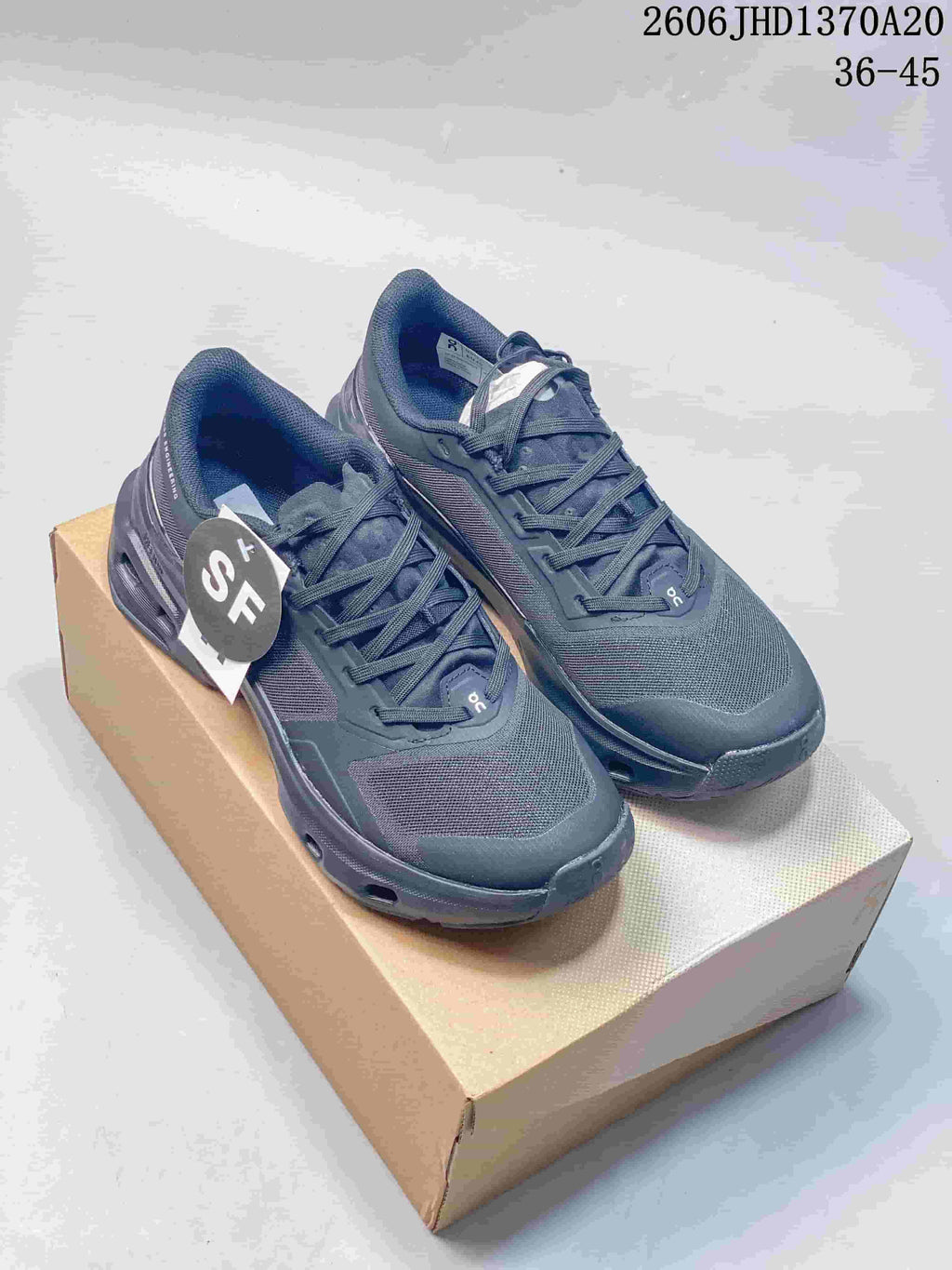 Pair of charcoal gray On Cloudpulse 2 sneakers displayed on a shoebox.