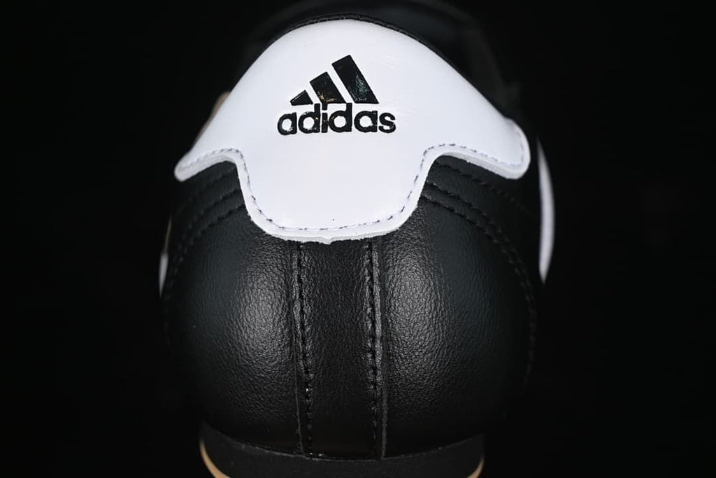 Rear view of the sneaker with a white heel panel and Adidas branding.