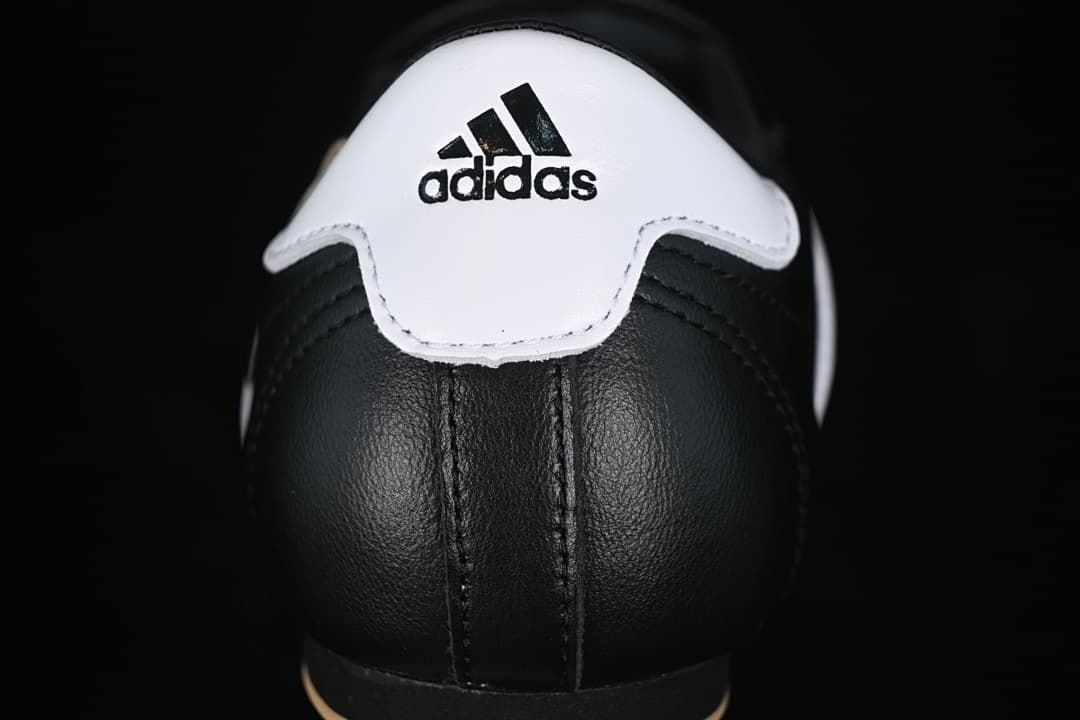 Rear view of the sneaker with a white heel panel and Adidas branding.