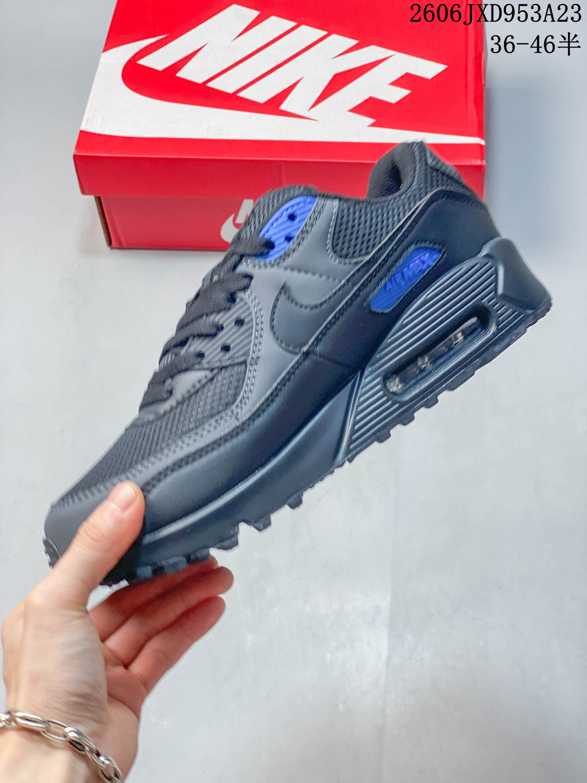 Side view of the gray and blue Nike Air Max 90 showing the heel window
