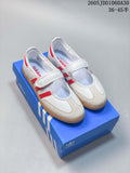 Pair of white Adidas Samba Jane sneakers with red stripes, hook-and-loop straps, and gum-colored soles