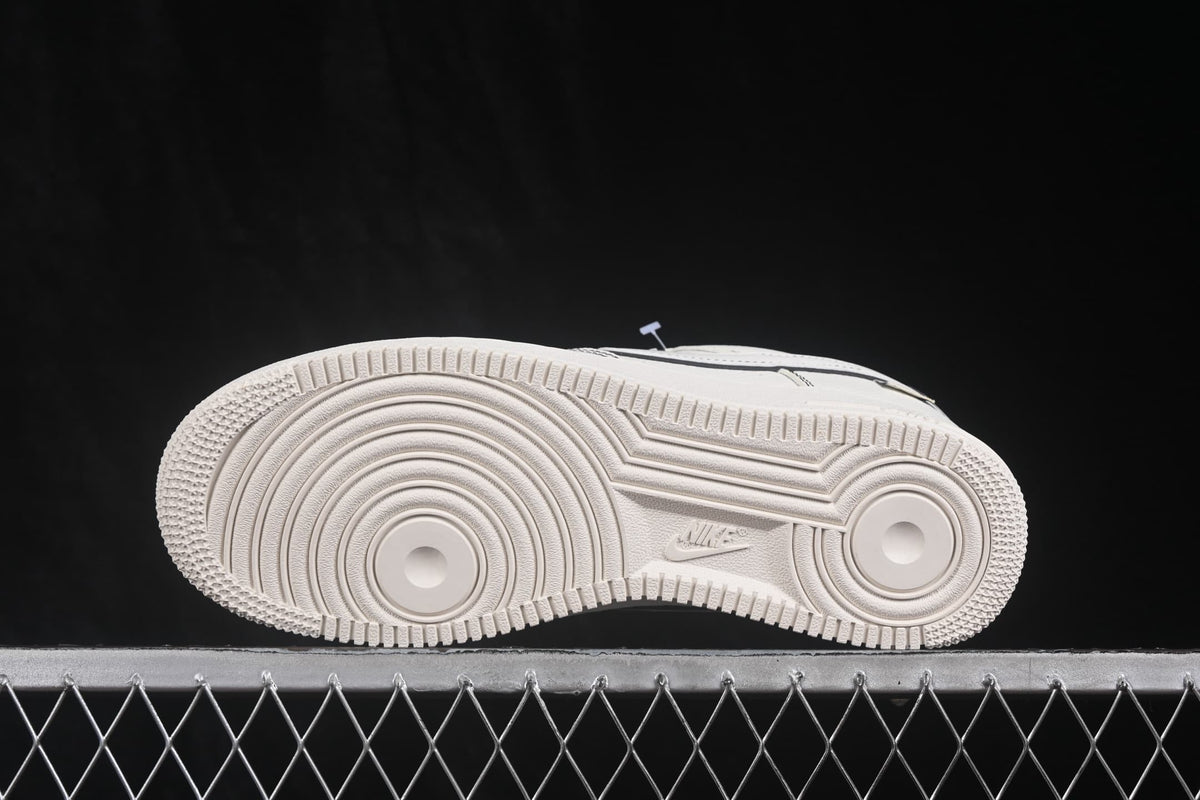 Side view of the white outsole with circular forefoot and heel traction grooves.