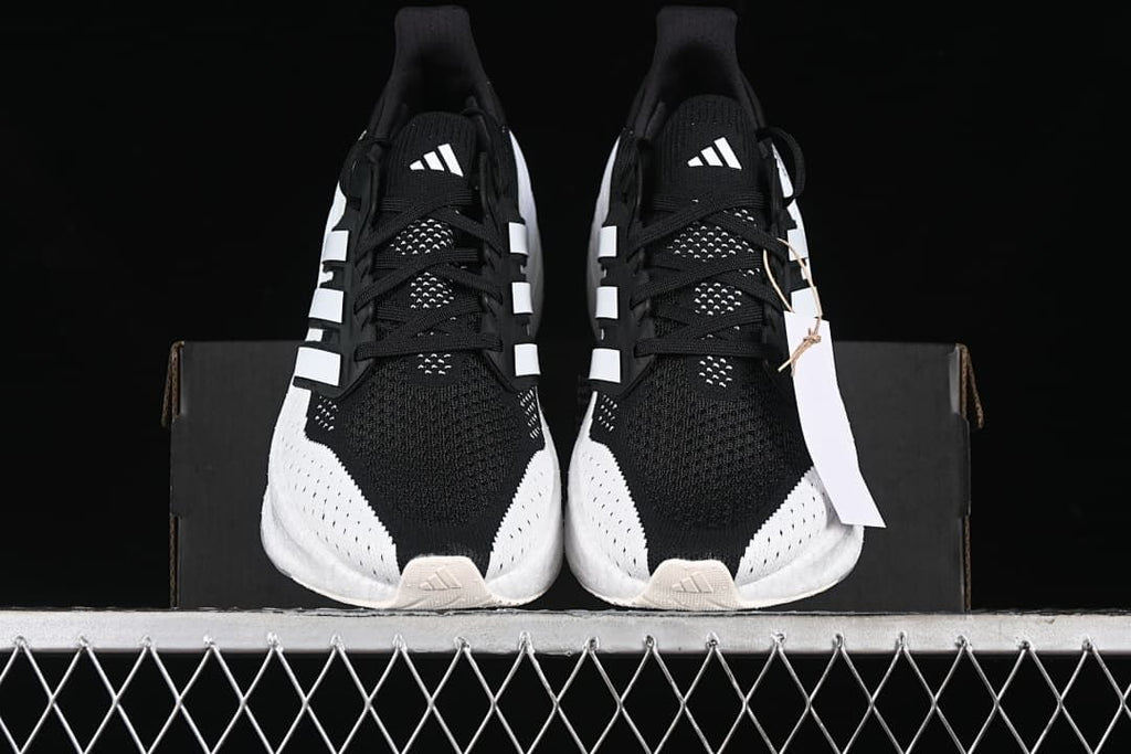 Front view of the pair showing black uppers and white detailing