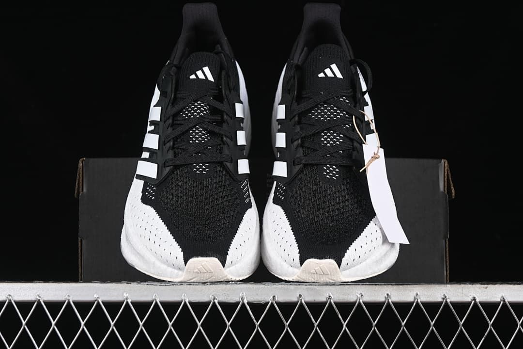 Front view of the pair showing black uppers and white detailing