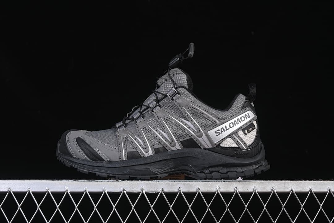 Side view of a gray Salomon XA Pro 3D trail shoe with black outsole and silver side branding.