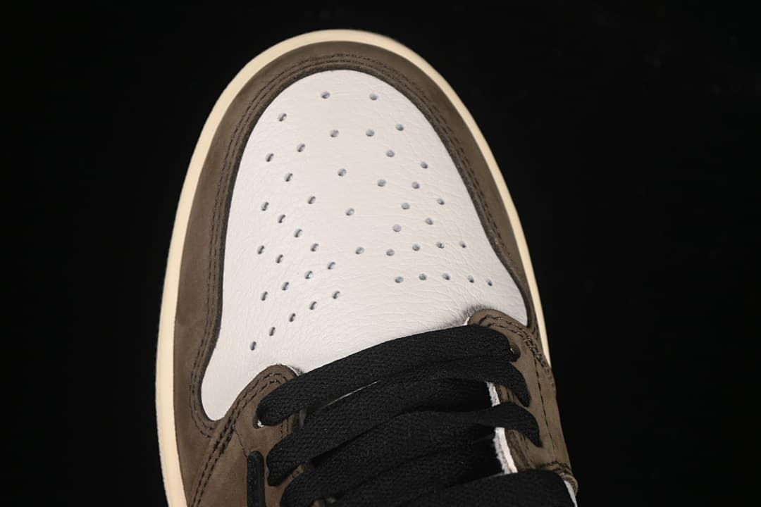 Top view of the perforated white toe panel and black laces