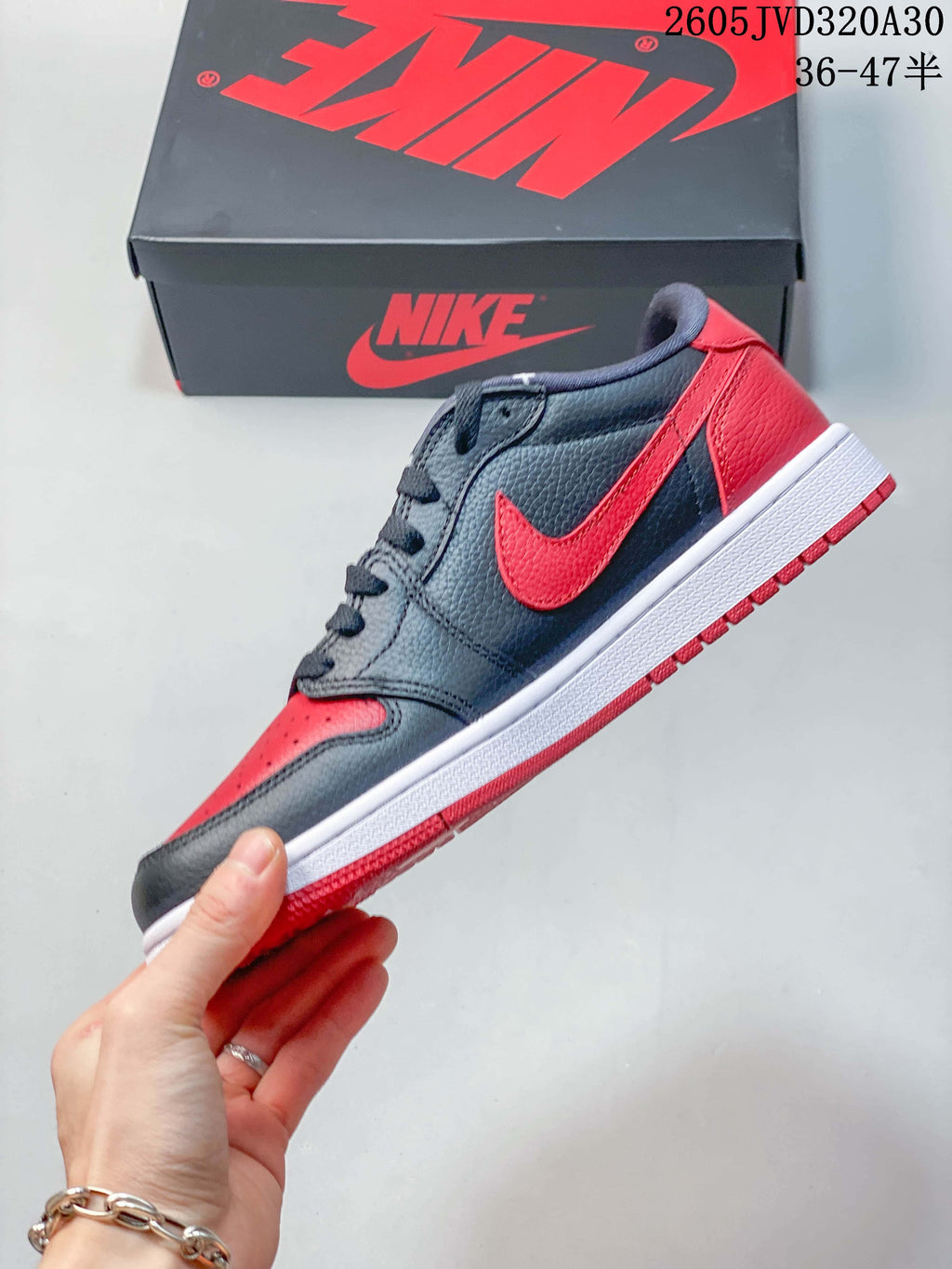 Side view of the low-top sneaker with red Swoosh and color-blocked panels
