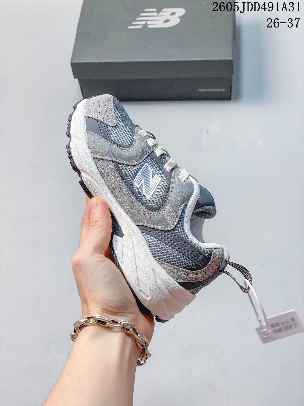 Side profile of a gray New Balance 530 kids' sneaker