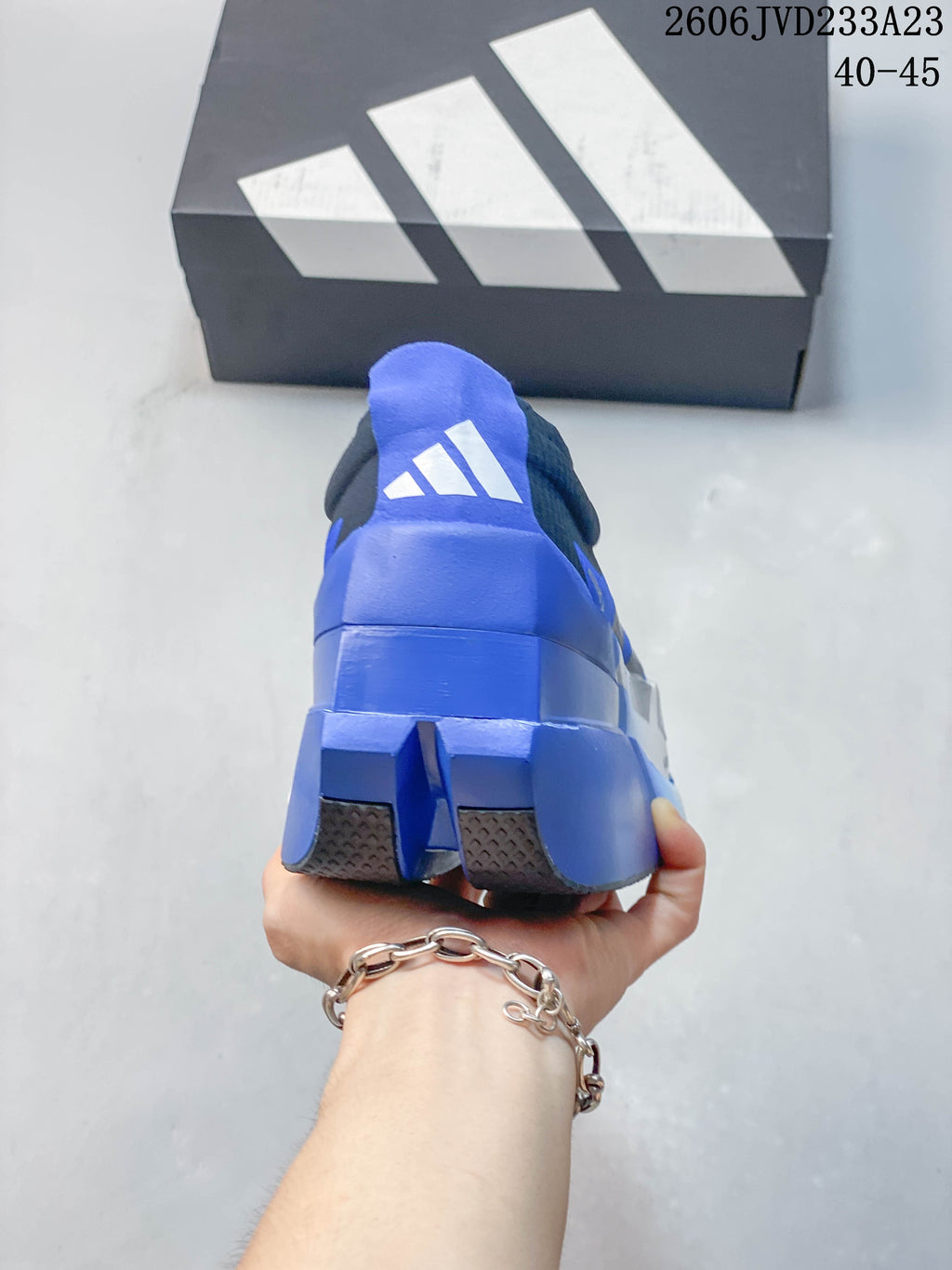 Rear view of the blue running shoe with Adidas branding and split outsole sections