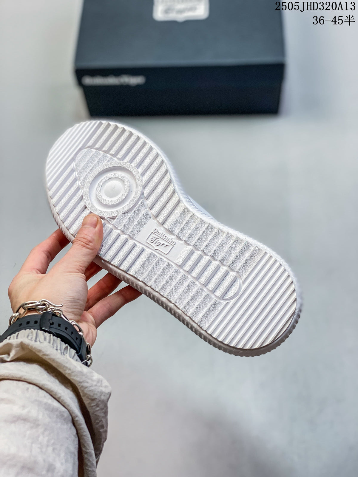 View of the white sneaker's ribbed outsole and tread.