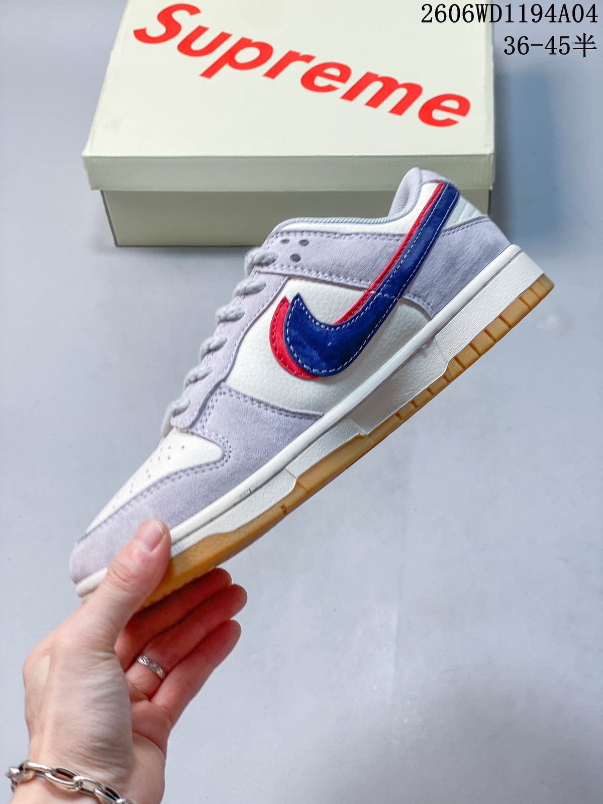 Side view of the low-top sneaker with blue and red Swoosh accents