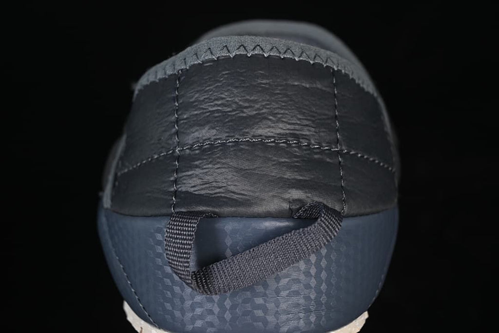 Rear view showing the heel panel, blue sidewall and pull loop