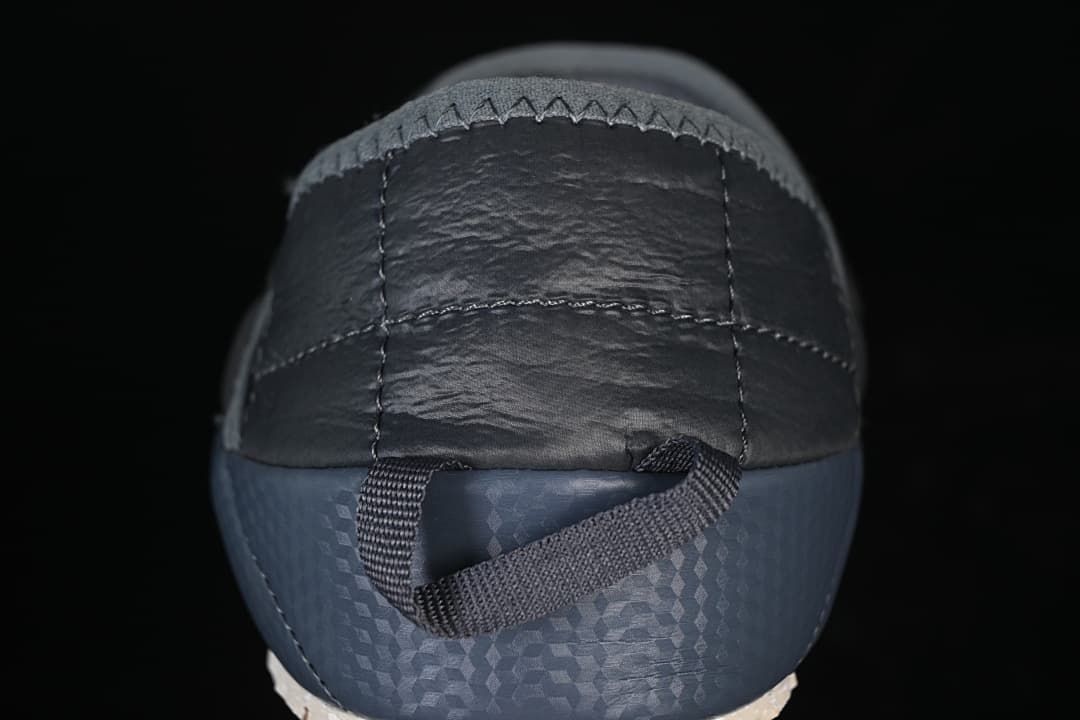 Rear view showing the heel panel, blue sidewall and pull loop