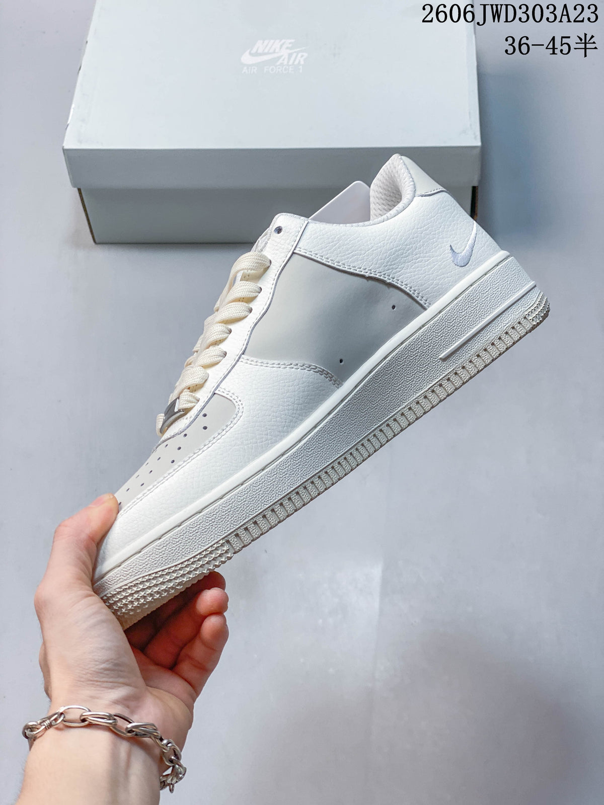 Side profile of a white low-top sneaker with a Swoosh detail
