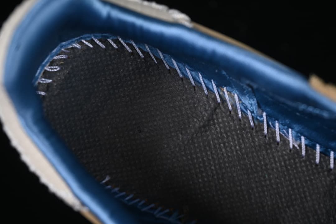Close-up of blue shoe lining and stitched insole edge