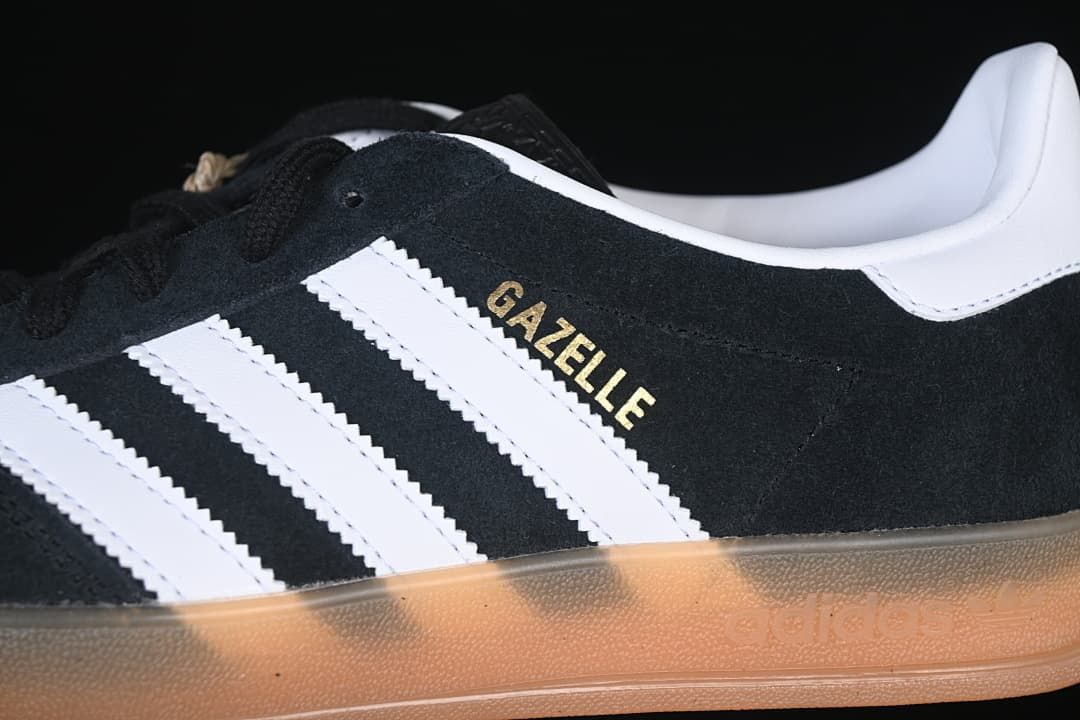 Close-up of the black upper, white stripes, and gold-tone Gazelle lettering.