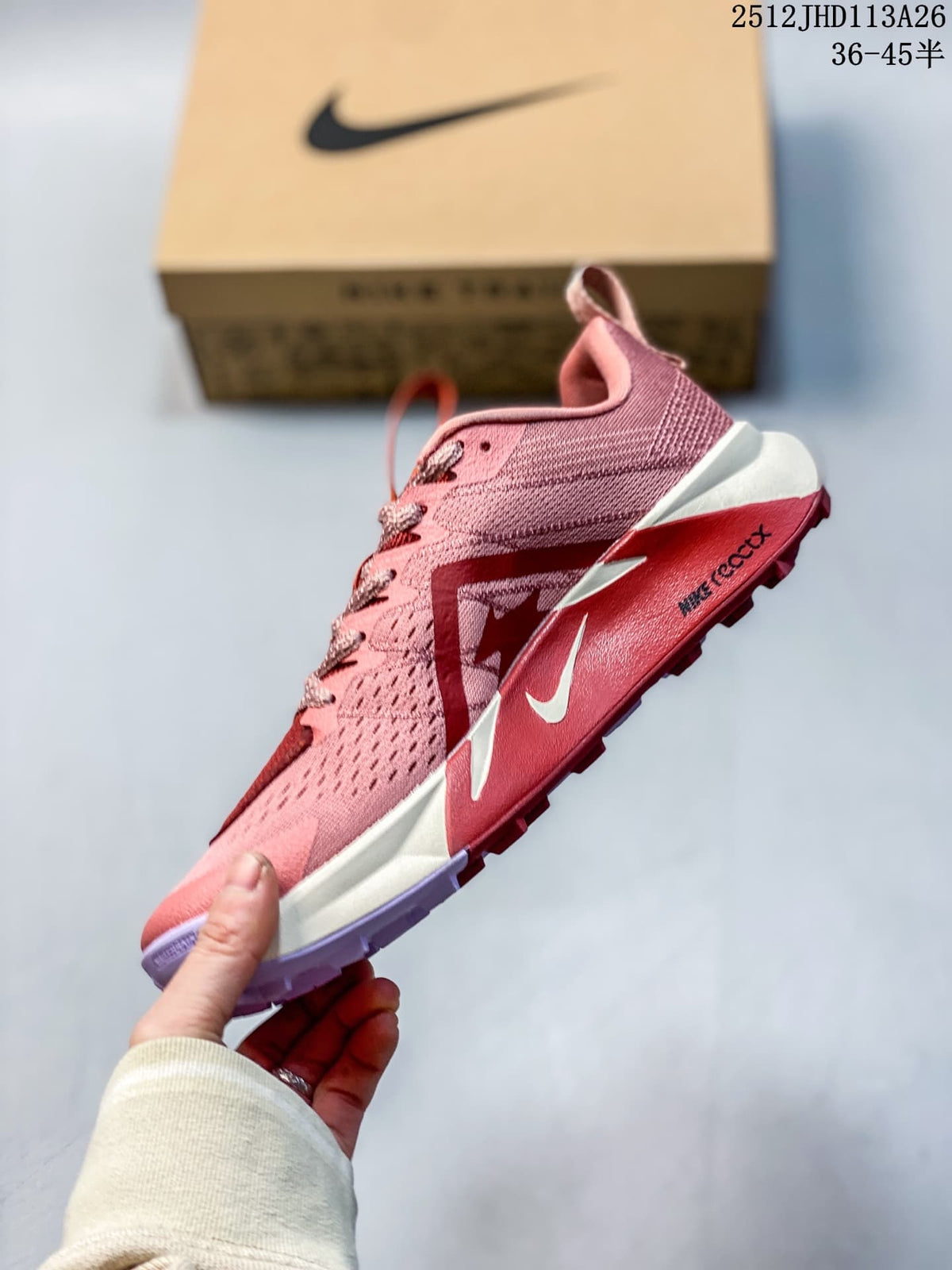 Side profile of the rose-pink Nike Wildhorse 10 with dark accents and light midsole.