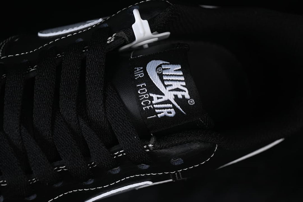 Close-up of the black lace tongue with Air Force 1 branding