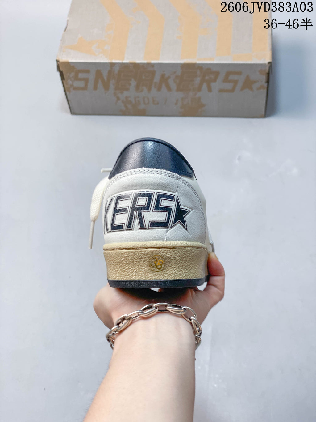 Rear view of sneaker showing navy heel detail and lettering