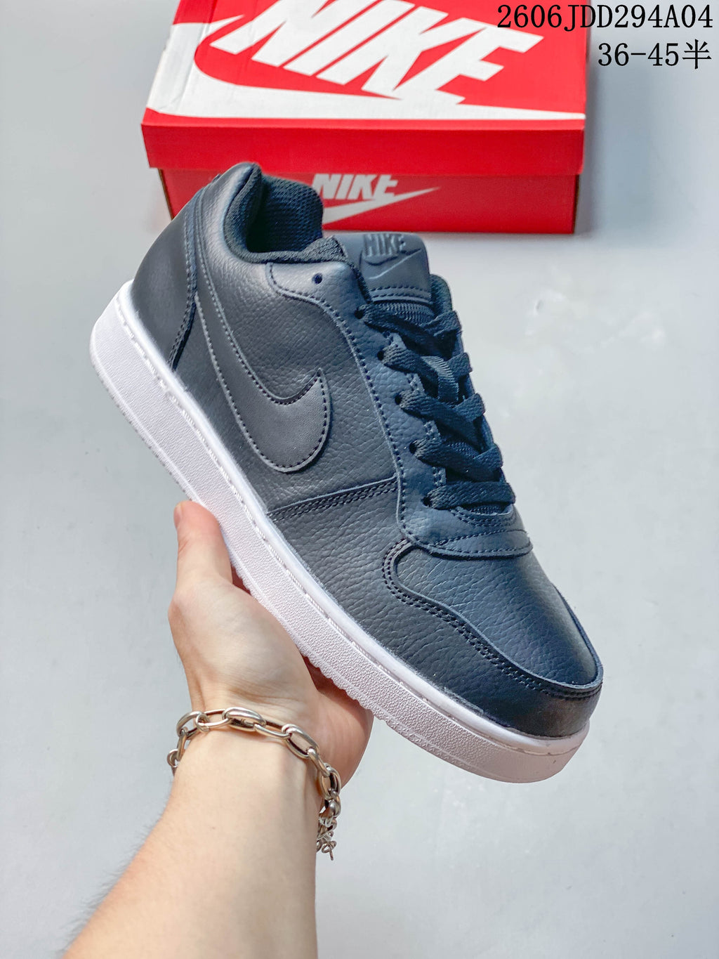 Side view of a dark navy Nike Ebernon Low sneaker with a matching Swoosh and white sole.