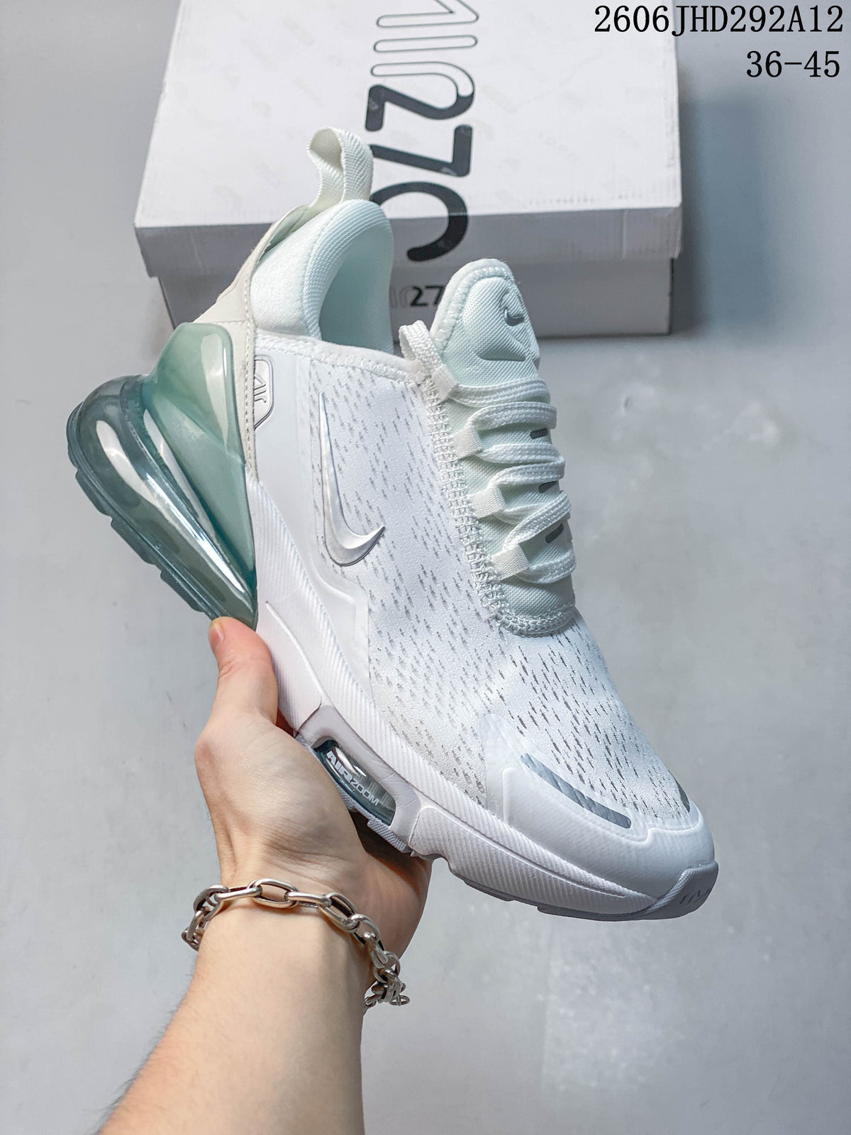 Angled side view of the sneaker with a gray Swoosh and translucent teal-toned heel.
