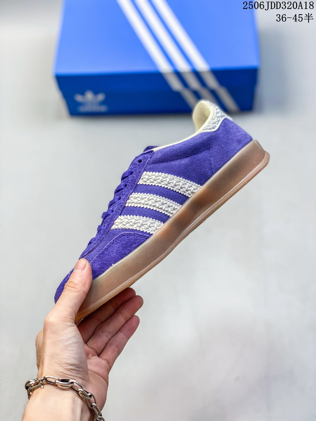 Side view of the purple low-top sneaker with cream stripes and gum-colored outsole.