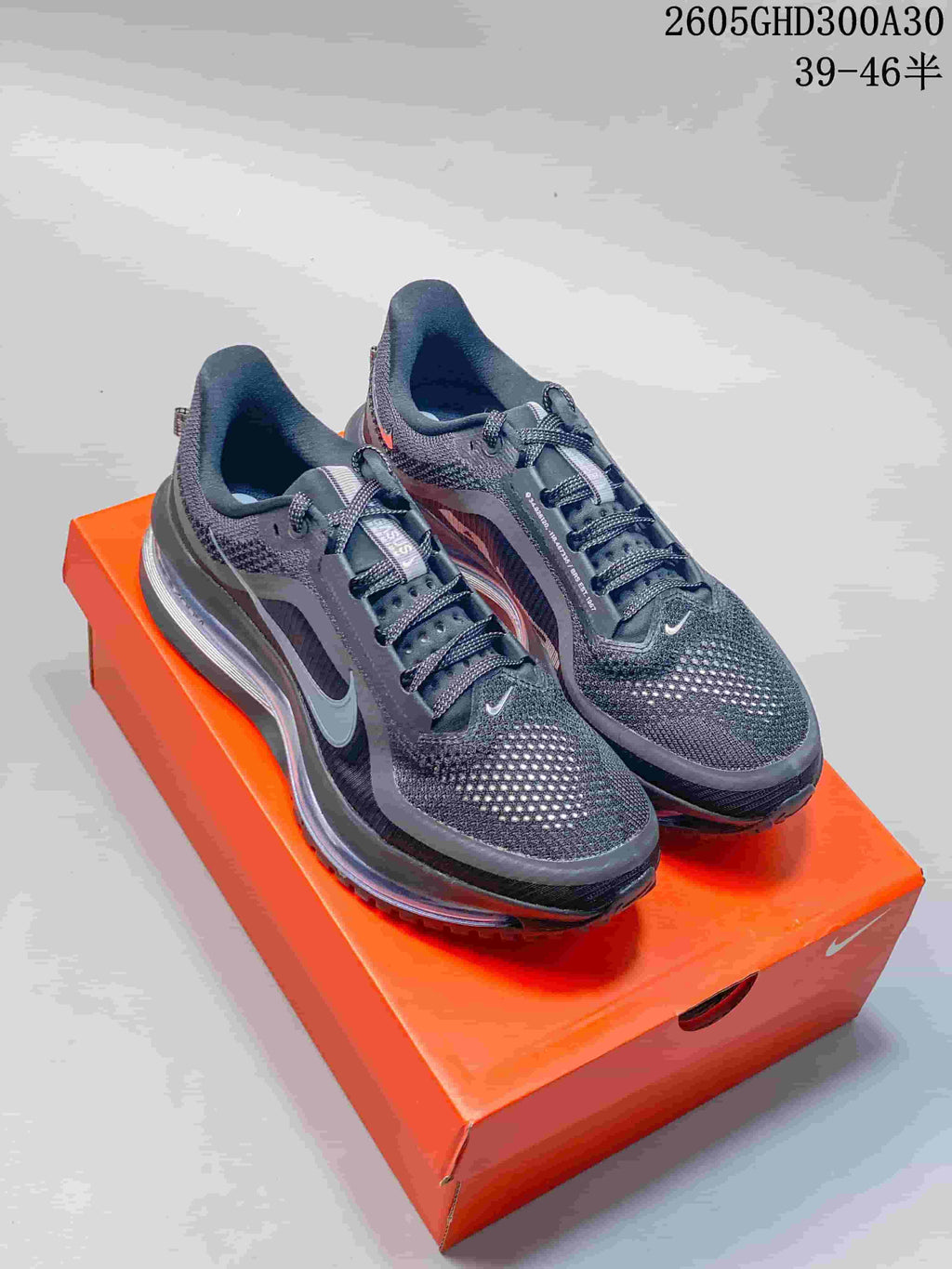 Pair of charcoal Nike Pegasus Premium running shoes on an orange shoebox.