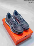 Pair of charcoal Nike Pegasus Premium running shoes on an orange shoebox.