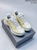 Pair of white KAILAS low-top hiking shoes with pale lime details, shown from above on a shoebox.