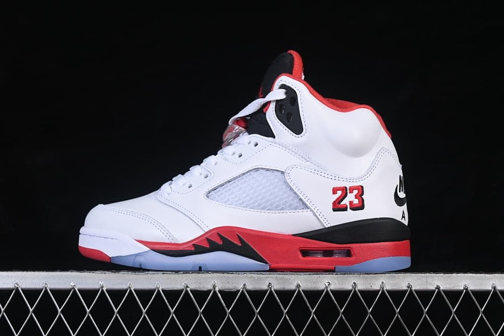 Side view of a white, red, and black Air Jordan 5 Retro high-top sneaker
