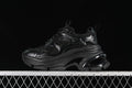 Side view of a black G24X9833 sneaker with a chunky platform-style sole.